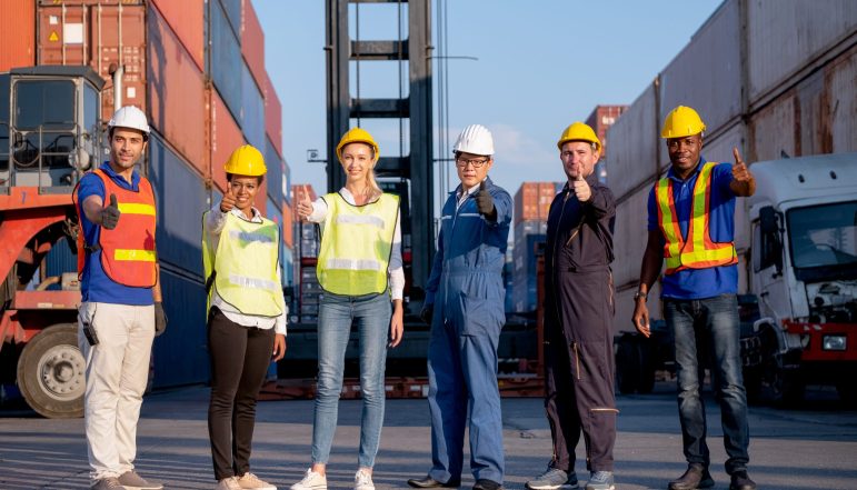 group-of-foreman-and-cargo-container-workers-or-te-2025-03-05-02-32-09-utc Group of foreman and cargo container workers or technician stand in row and show thumbs up to camera for symbol of successful in delivery and transport system business.